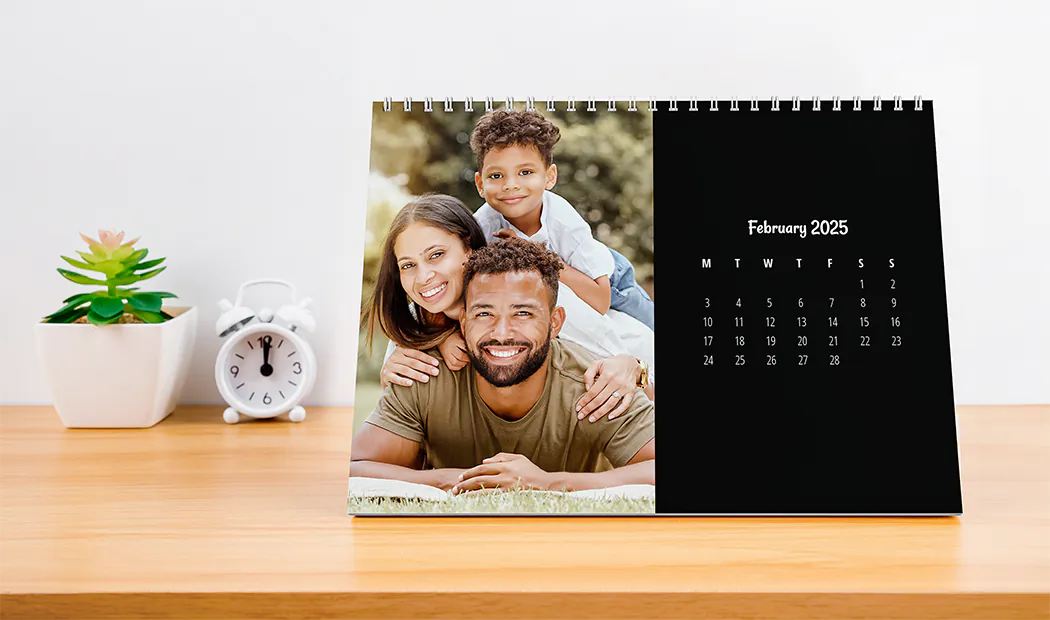 Woman writing on A4 customised wall calendar by printerpix with christmas theme photo